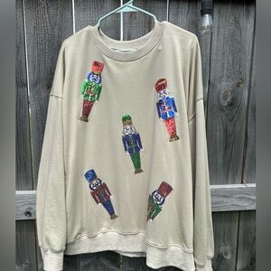 Women’s beige sweatshirt with nutcrackers.